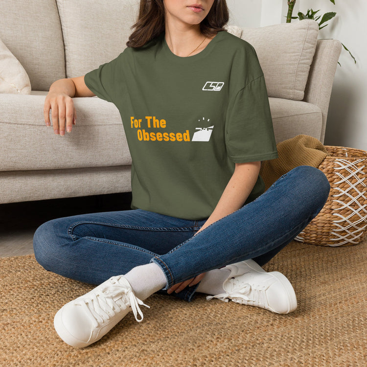 For The Obsessed t-shirt, Military Green, worn seated on floor